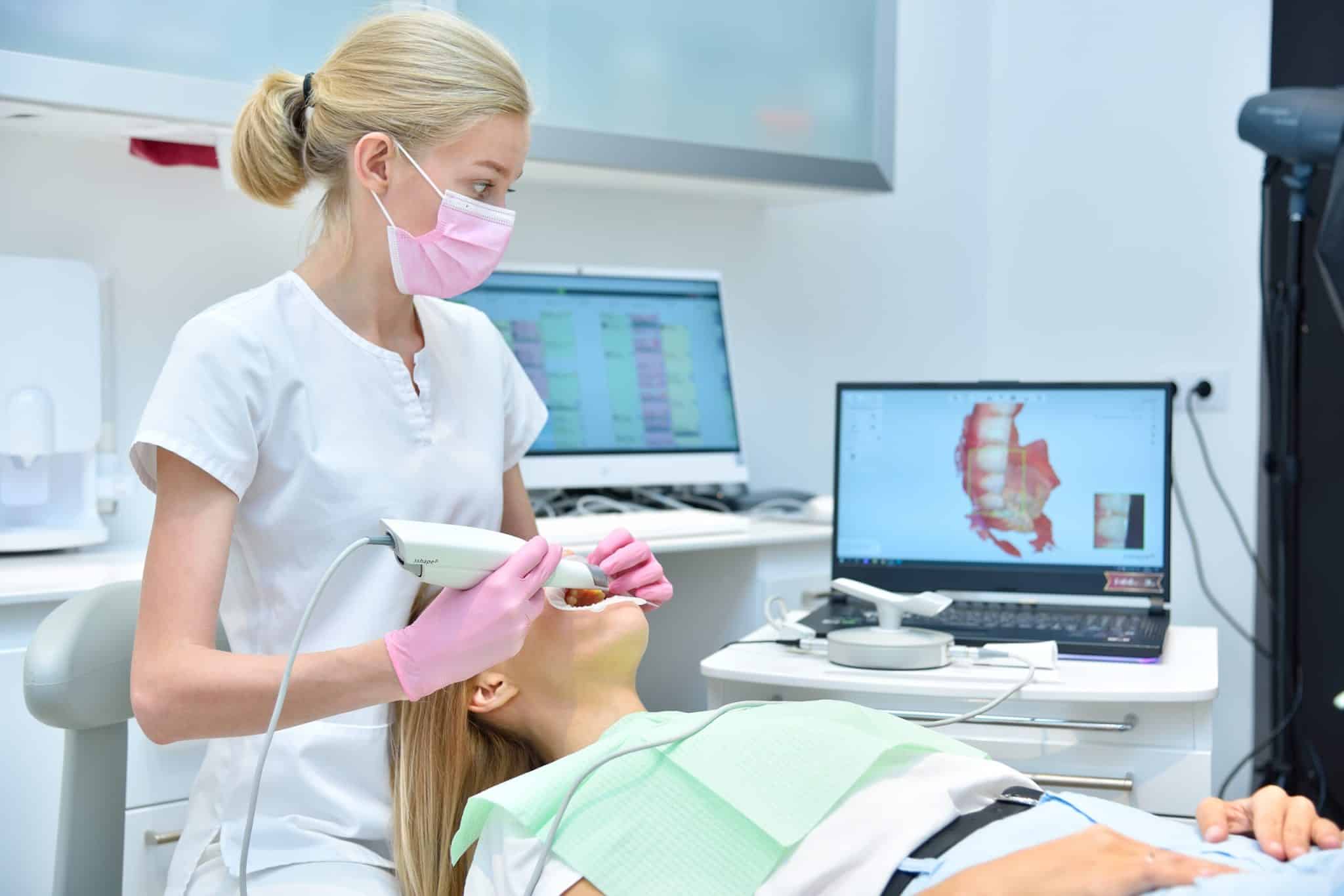 Orthodontist scanning patient with a dental intraoral scanner