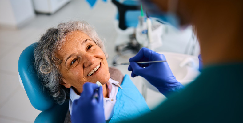 Elderly patient smiling at dentist