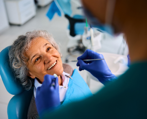 Elderly patient smiling at dentist