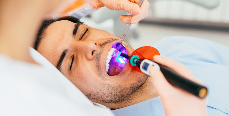 Dentist restoring patients teeth