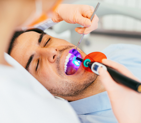 Dentist restoring patients teeth