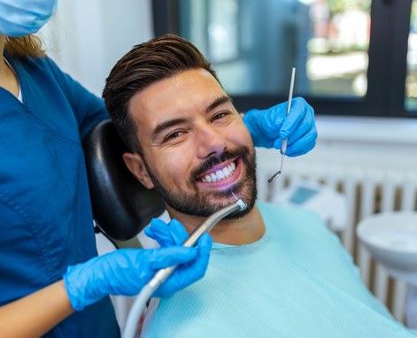 dentist examining mans smile